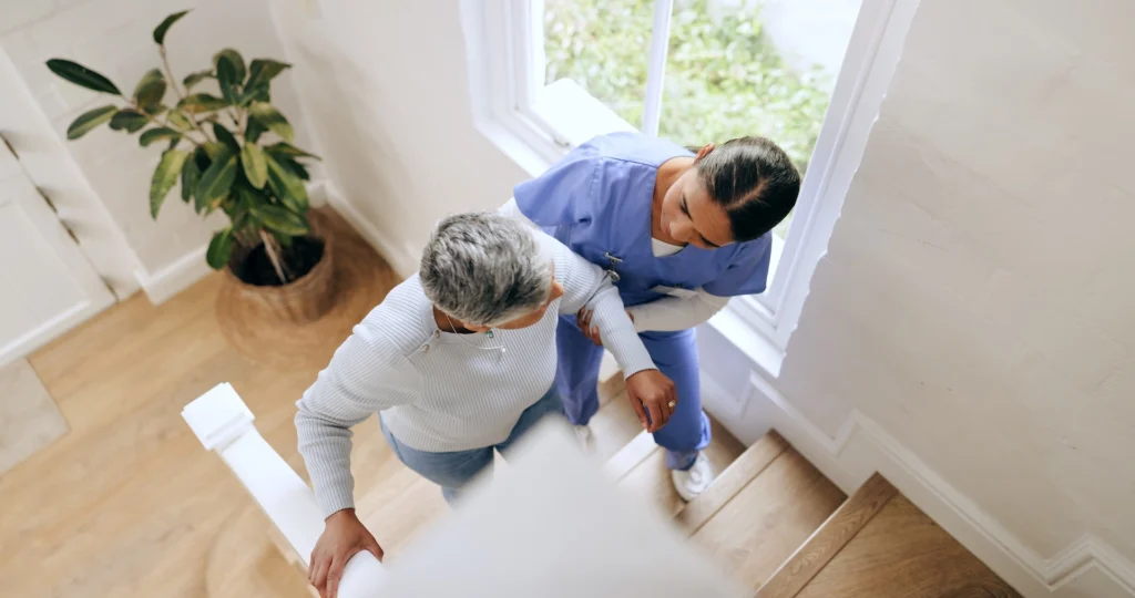 caregiver and woman goign up stairs