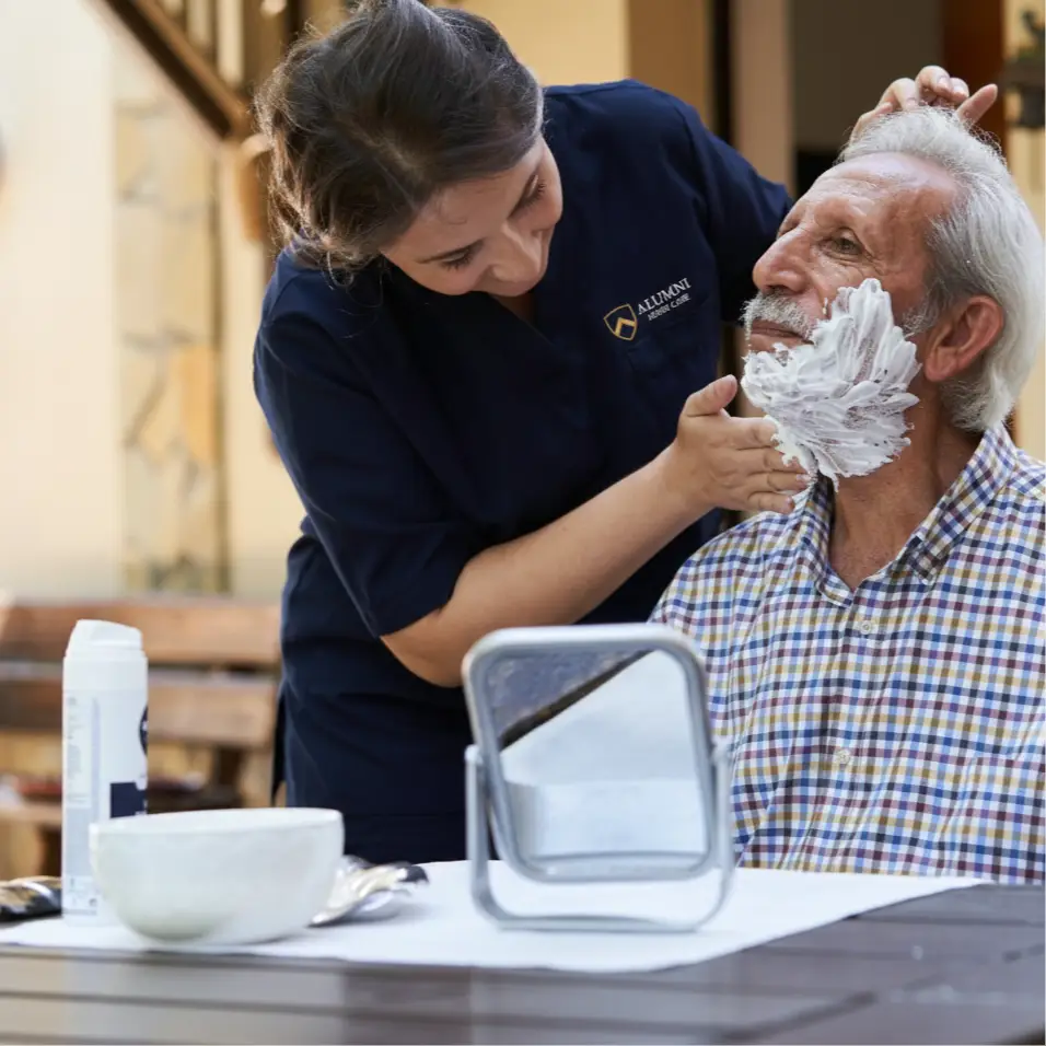 alumni home care helping man shave (1)
