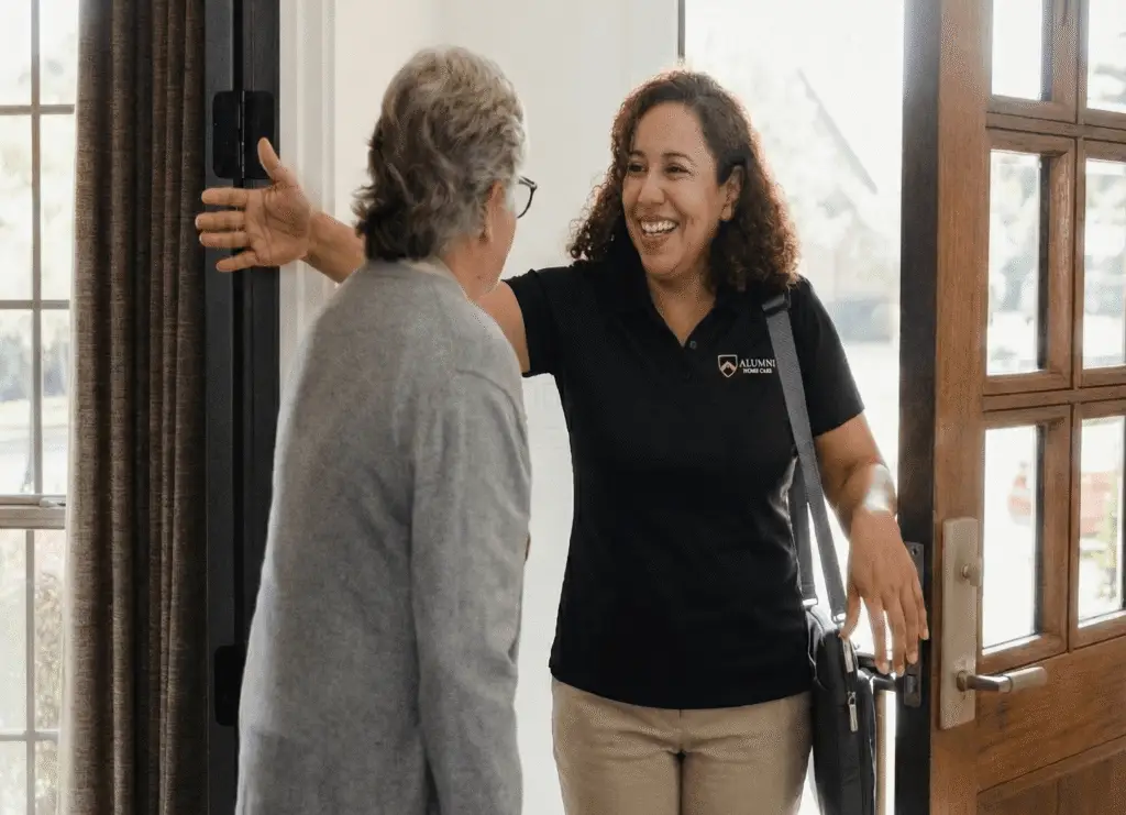 caregiver at front door in alumni home care polo